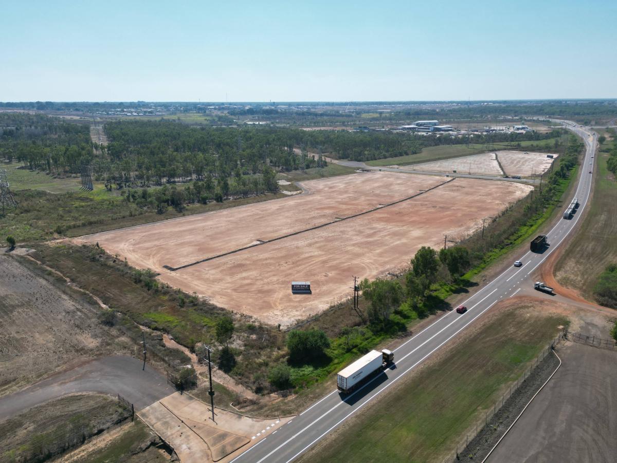Aerial view of serviced industrial lots at Wishart Estate with direct highway frontage and passing heavy vehicle traffic 